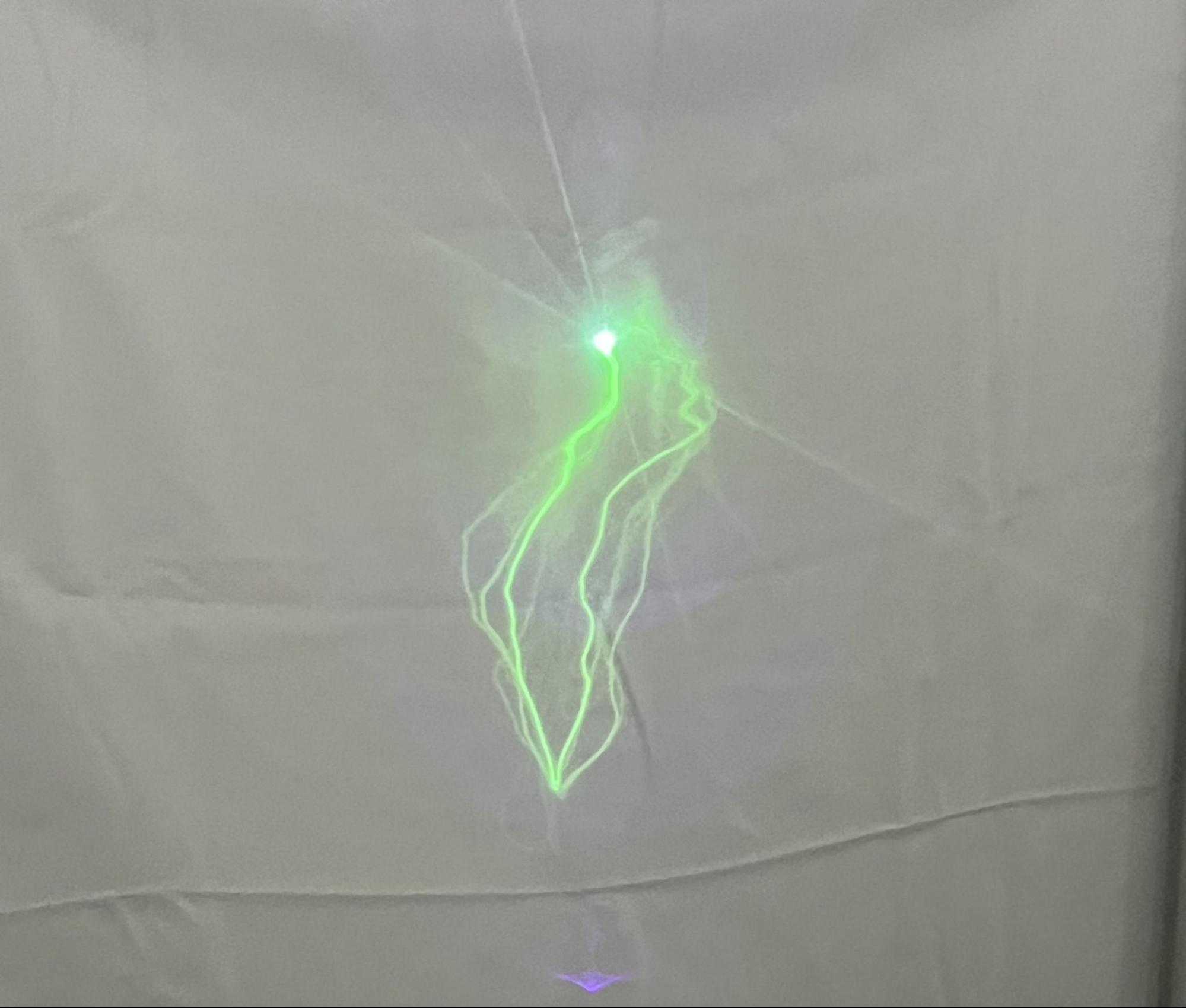 A continuous glowing trace made by a single fully stationary laser point