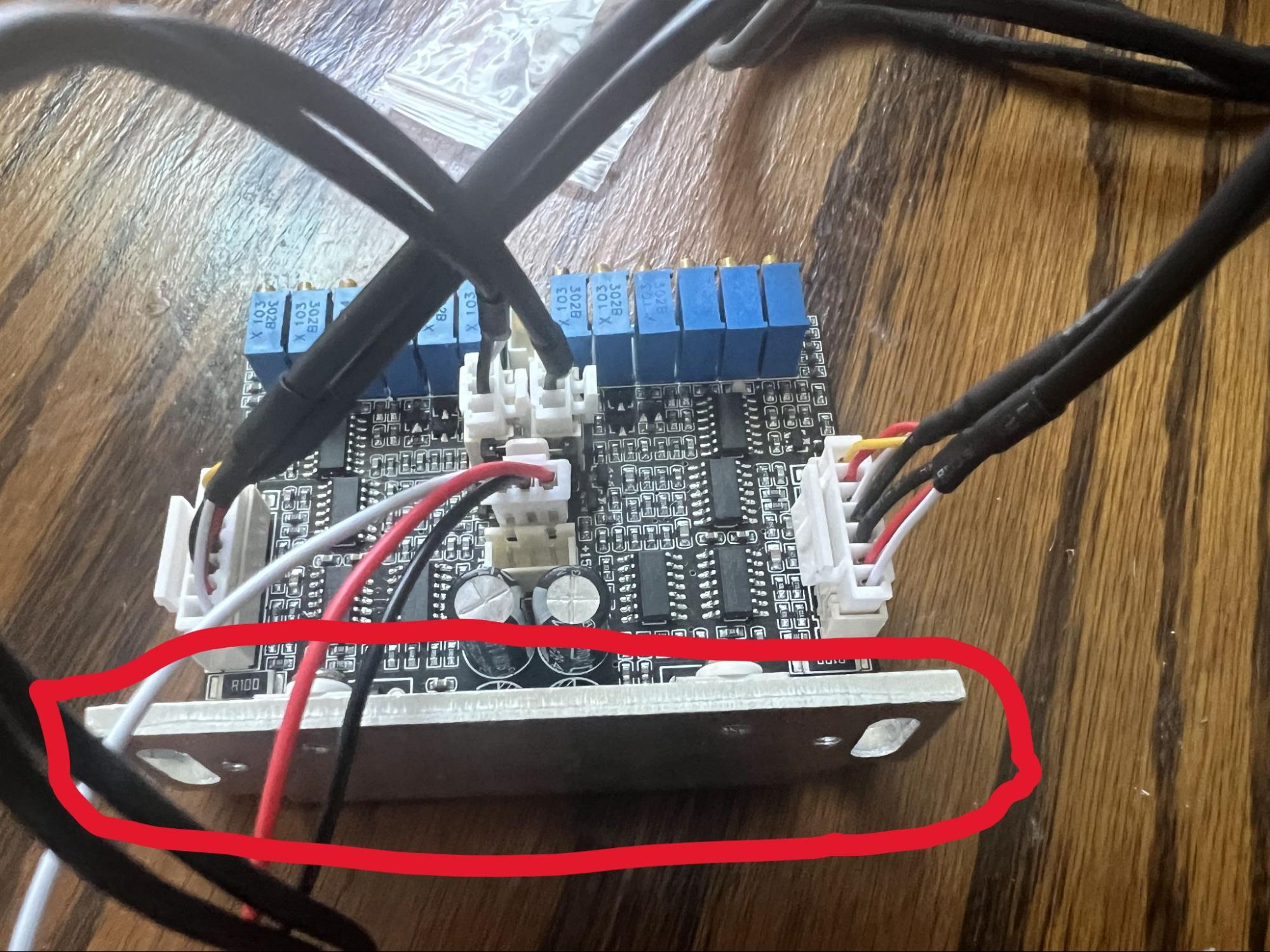 The galvo driver board with its small aluminum heatsink circled in red