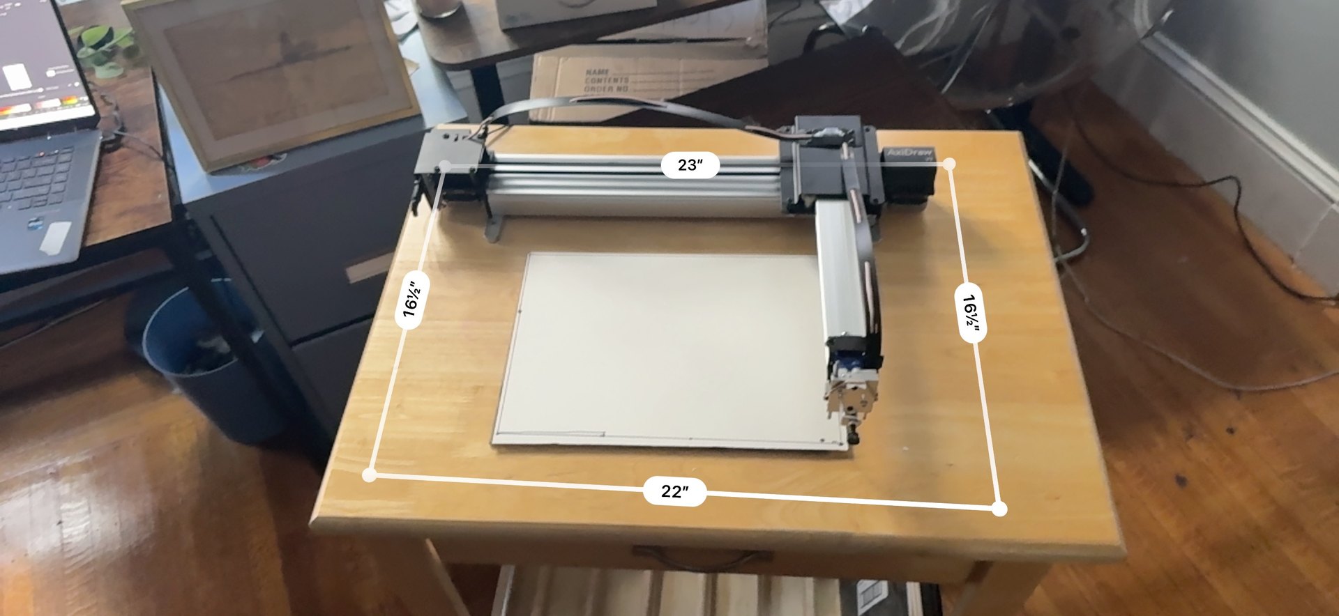 The plotter on a wooden board with measurements marked out