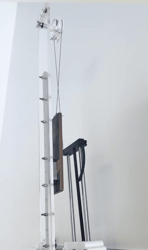 The counterweight sliding along the linear rail as the arm moves